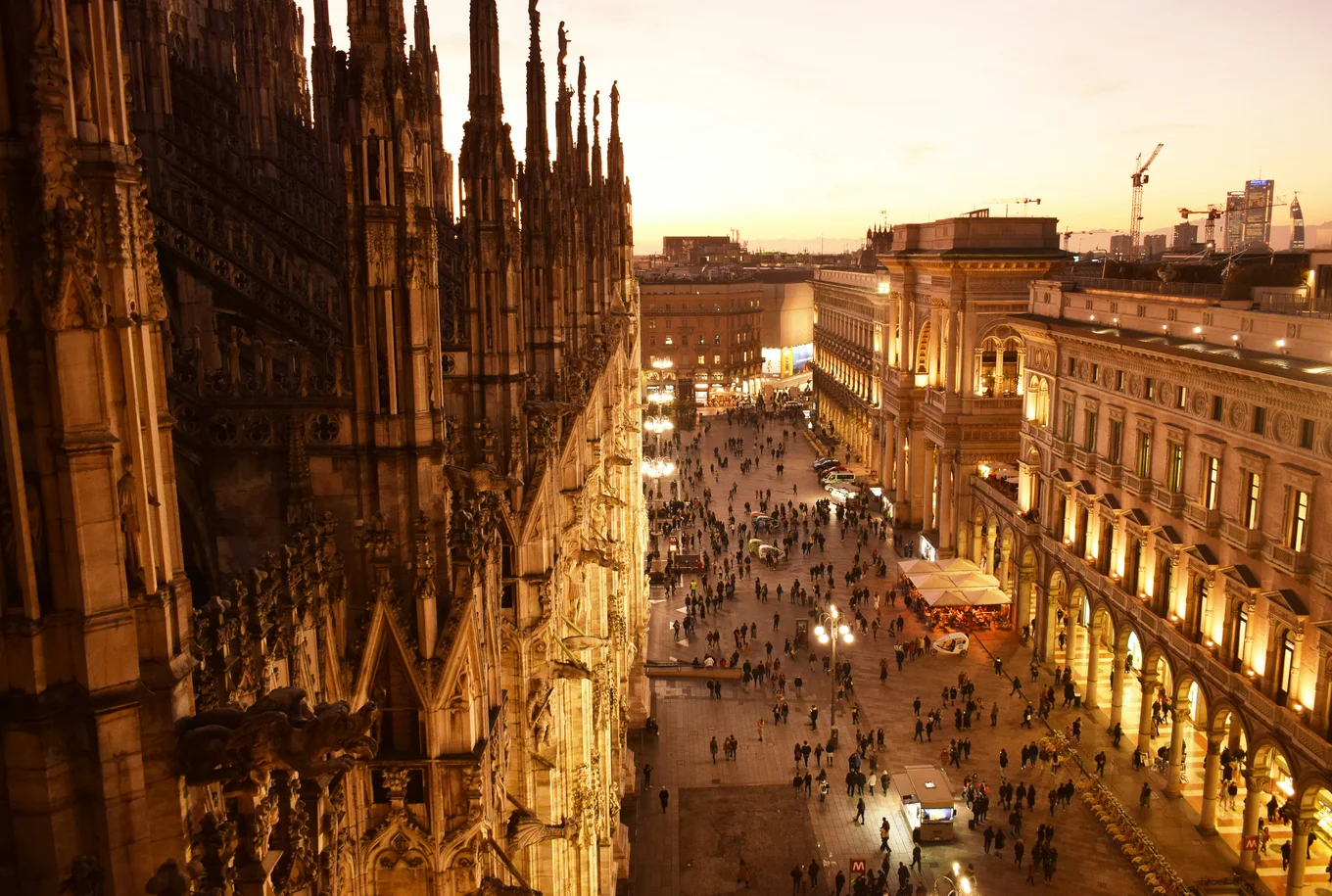 A view from the roof of the Duomo di Milano down onto a square at sunset