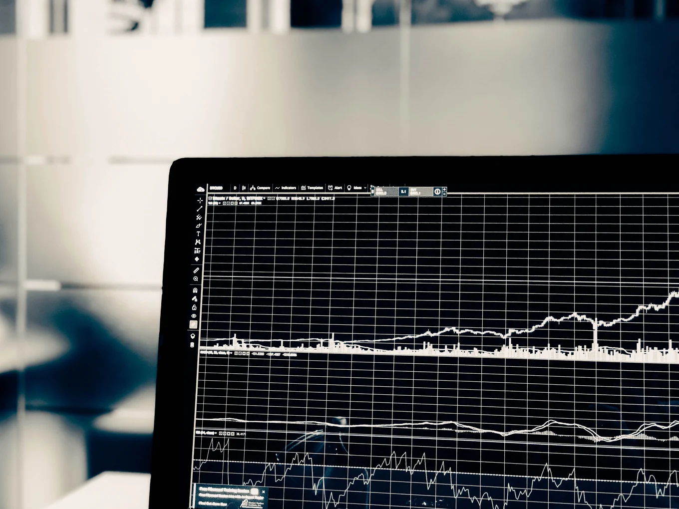 Laptop screen displaying financial graphs.