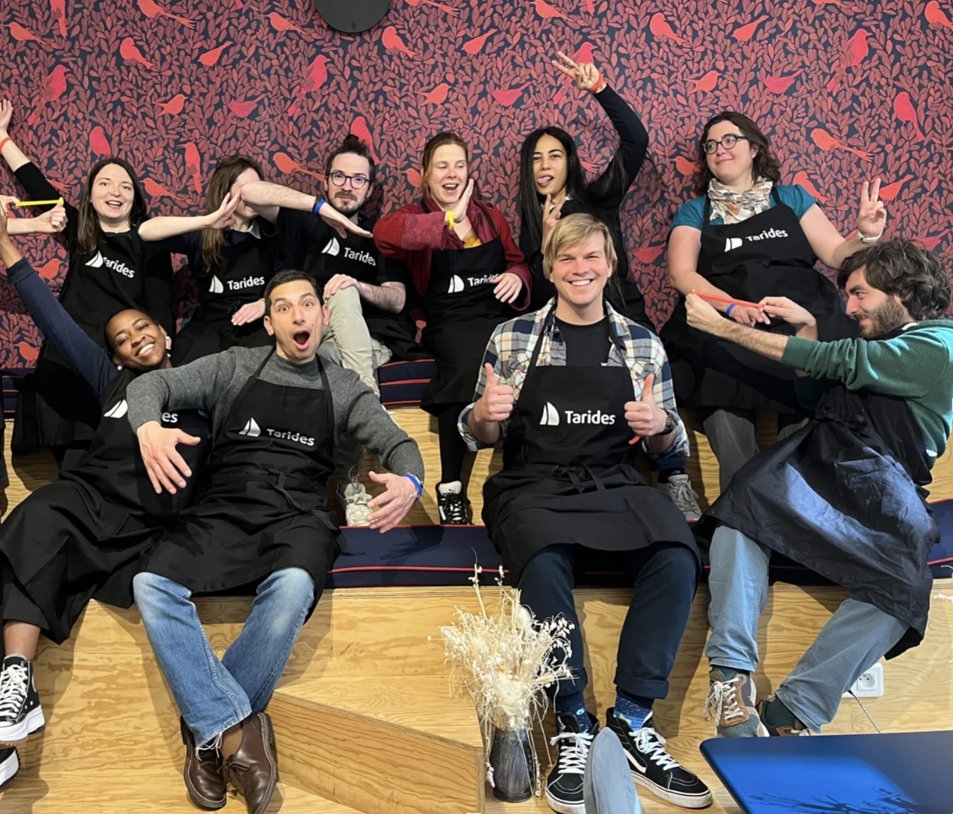 The Tarides team posing for a photo in aprons, preparing to make chocolate cakes.